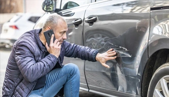 man in car accident on phone